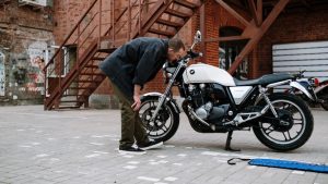 A Man Looking at a Motorcycle | Breast Cancer Car Donations