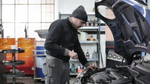 Photo of Man Inspecting Car Engine | Breast Cancer Car Donations