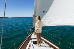 contemplating sea from yacht during summer trip | Breast Cancer Car Donations