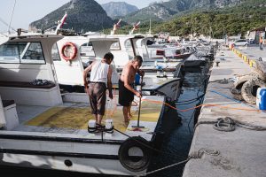 Men Cleaning the Boat Deck | Breast Cancer Car Donations