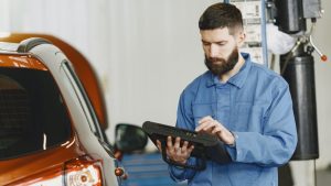 Man doing a car diagnostic | Breast Cancer Car Donations