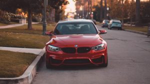 Red Car Parked on the Side of the Road | Breast Cancer Car Donations