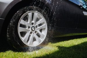 Water being Sprayed on a Wheel of a Car | Breast Cancer Car Donations